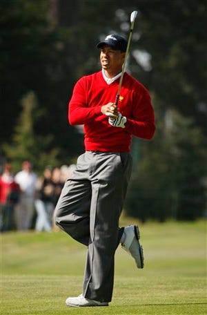 United States' Tiger Woods hits his approach to the eighth hole of his foursomes match at golf's Presidents Cup at Harding Park Golf Course, Thursday, Oct. 8, 2009, in San Francisco. (AP Photo/Eric Risberg)