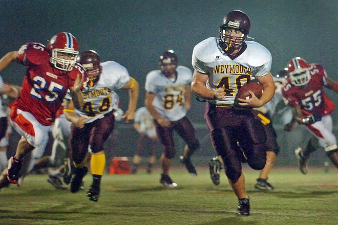 Weymouth's Dylan Colarusso carries the ball for a first down against Milton.