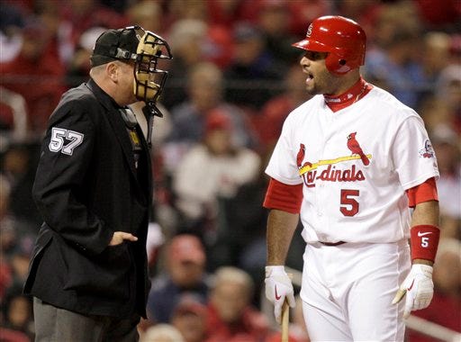 St. Louis Cardinals' Albert Pujols, right, yells at home plate umpire Mike Everitt after being called out on strikes during the sixth inning in Game 3 of the National League division baseball series against the Los Angeles Dodgers Saturday, Oct. 10, 2009, in St. Louis. (AP Photo/Jeff Roberson)