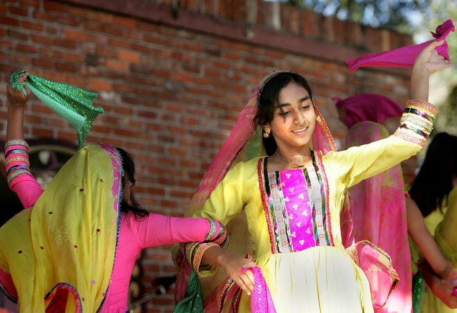 A group of young women from the Pakistani-American Cultural Society perform a Larshape dance during the Pakistan Day Celebration at the Bo Diddley Downtown Community Plaza Sunday afternoon.