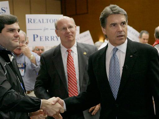 Texas Gov. Rick Perry, right, greets people after a luncheon meeting with the Texas Association of Realtors Wednesday, Oct. 14, 2009, in Austin, Texas.