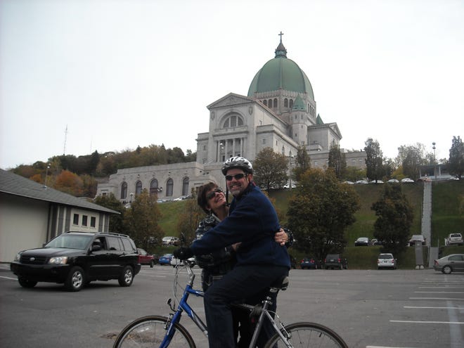 Peter and Andrea Cahill of Hingham pose near  St. Joseph’s Oratory in Montreal after Peter finished a bicycle ride to raise money for neurofibromatosis research. The disease cost Andrea her hearing.