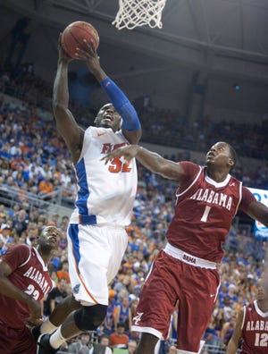 PHIL SANDLIN/Associated PressFlorida's Erving Walker (11) tries to steal the ball from Alabama's Senario Hillman during a game last season in Gainesville. Walker is the only true point guard on the Gators' roster.