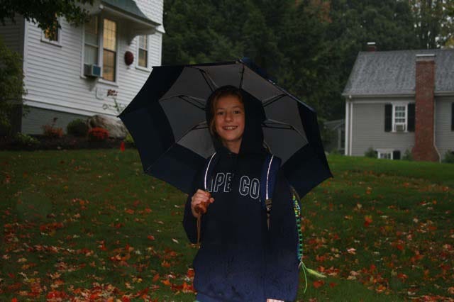 Ally Barth, a fifth-grader at Peter Noyes Elementary School, walks to school in the rain on Oct. 7, during International Walk to School Day.