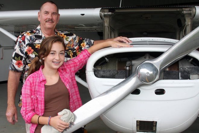 Photos by MAGGIE FITZROY/StaffElif Turker, 11, of Ponte Vedra Beach and Steve Price of Jacksonville Beach stand next to a two-seater Cessna at Craig Airport, where Elif takes flying lessons through the Stephen M. Price Foundation's "Young Aviators" program.