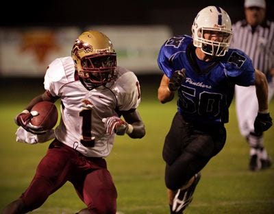 North Marion's Jamie Gilmore runs the ball Friday night at Newberry.