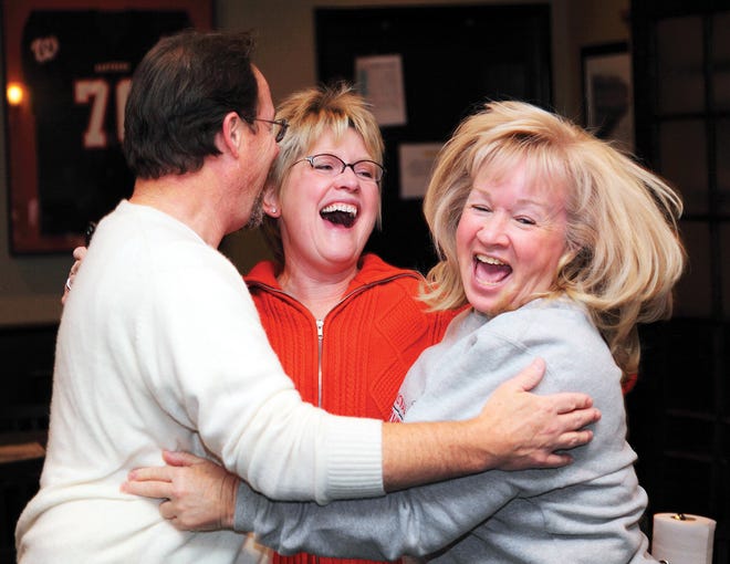 From left, Kevin Gall and Pattie Vanlandingham of Washington and Dee Lott of Eureka jump in excitement at Gracie’s Chicago Style Grill after winning the Washington Park District’s Amazing Race Saturday night.