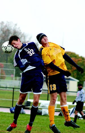 Kyle Crider goes high with a Camp Hill player for a header Saturday.