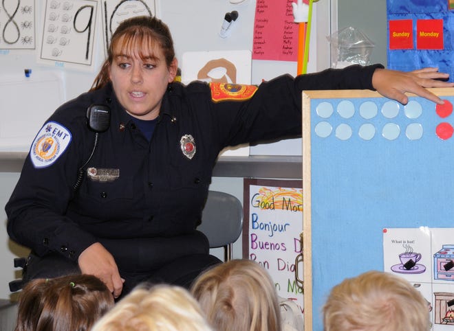 Upton firefighter Bonnie Lopez teaches a Memorial Elementary School kindergarten class about fire safety on Wednesday.