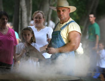 Chuck Stegall stirs sugar cane syrup at an earlier Ocali Country Days at the Silver River State Park in Ocala. This year’s celebration of 1800s life will be Nov. 14-15.