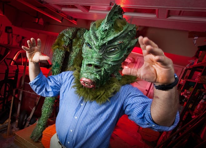 JON M. FLETCHER/The Times-UnionFlorida Times-Union reporter Matt Soergel tries on the head of Zaat, a creature featured in the 1970s film of the same name by Jacksonville resident and retired filmmaker Don Barton.
