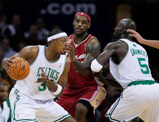 Boston’s Paul Pierce, left, who finished with 23 points, leads Cleveland’s LeBron James into Kevin Garnett's screen.