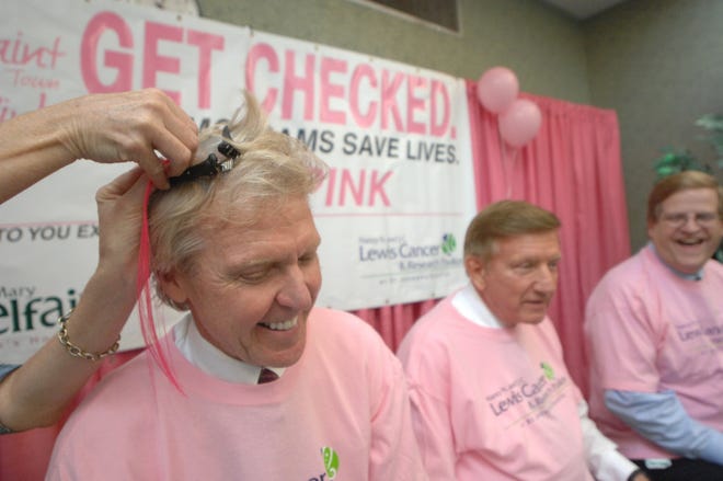 Paul Hinchey, CEO of St. Joseph's/Candler, gets a pink strip put in his hair as Pete Liakakis, Chatham County Commission chairman, and Michael C. Traynor, Savannah Morning News publisher, wait their turn Tuesday afternoon at St. Joseph's Hospital. Richard Burkhart/Savannah Morning News