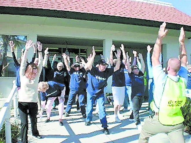 Rafe Hewitt leads participants in warm-up exercises at a previous year's lake walk. Contributed photo