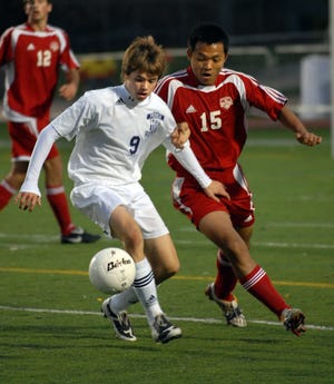 Peoria Christian junior Jonny Lehman, left, races Timothy Christian senior Dae He Cho to the ball during their class 1A state semifinal game Friday Oct. 30 at North Central College in Naperville.