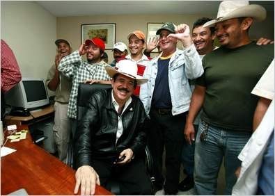 Honduras' ousted President Manuel Zelaya surrounded by his supporters, smiles at the Brazilian embassy in Tegucigalpa, Friday.