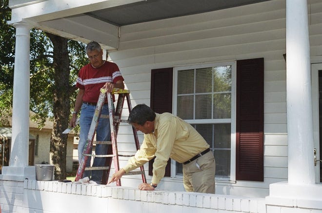 Members of Congregations in Service make repairs to a low-income residence. Courtesy of Debbie Bergman