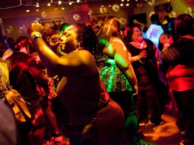 This photo taken Aug. 8, 2009 shows patrons dancing at Club Bounce in Long Beach, Calif. The club is specifically aimed at attracting overweight individuals.