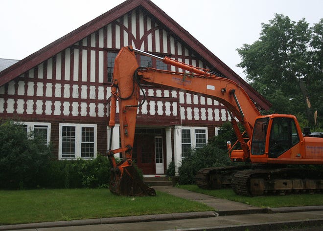 A large excavator is parked in front of the historic shovel factory complex in North Easton. The property is owned by developers George and Robert Turner. The brothers are in a dispute with the town over development of the property and have sought a permit to demolish the historic buildings.
