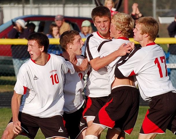 Coe-Brown's Blake Heyn, center, is mobbed by teammates after scoring the game-winning goal in the Class I soccer playoffs against Hollis-Brookline Sunday. Also pictured, from left, are Corey Gerlt, Zach Branco, Heyn, Doug Marshall and Sam Bassett.
Whaley/ Democrat photo