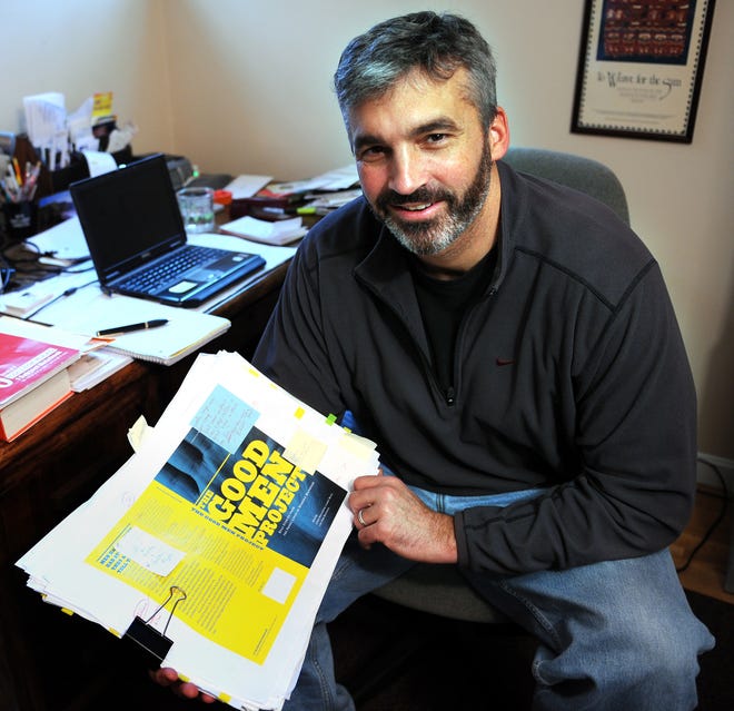 Larry Bean of Natick holds galleys of a new book he edited, "The Good Men Project."