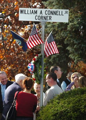 A crowd gathers Sunday for a dedication ceremony in which the corner of Torrey and Pleasant streets in Weymouth was named for the late veterans advocate William A. Connell Jr., who was a state representative, a town official and a Navy commander. Top: Connell’s widow, Joan, and son Bill attend the ceremony. The elder Connell, a veteran of two wars, died in 2008.