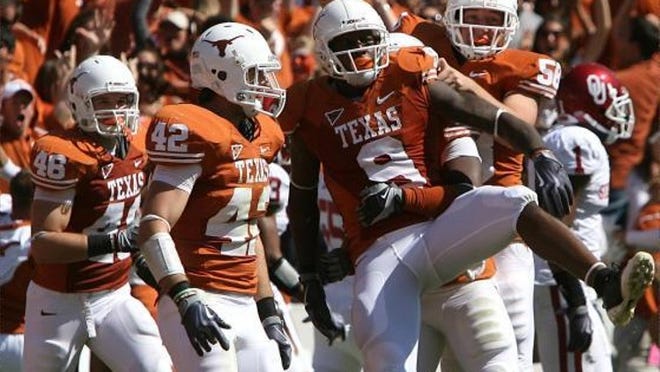 Texas' Malcolm Williams (9) celebrates his fumble recovery, which came after Oklahoma's Dominique Franks (far right, background) mishandled a punt return during the second quarter. Deon Beasley hit Franks to knock the ball loose, and Williams grabbed it.