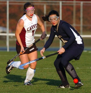 From left, Carver's Taylor Gray and East Bridgewater's Melissa Souza go after a loose ball.