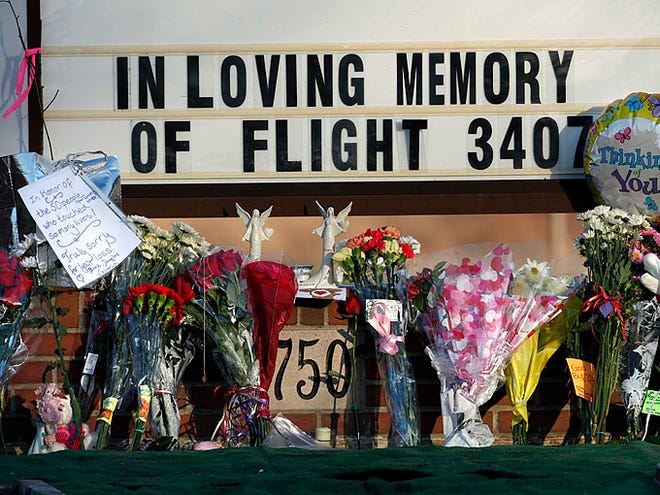 Flowers and notes are seen at a makeshift memorial to the victims of Continental Connection Flight 3407, outside the Clarence Center United Methodist Church, Sunday, Feb. 15, 2009, in Clarence, N.Y.