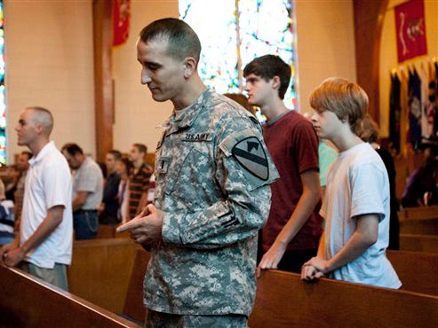 A soldier attends a church service at 1st Cavalry Division Memorial Chapel at Fort Hood in Killeen on Sunday Nov. 8, 2009.