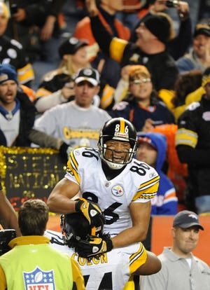 Pittsburgh Steelers Willie Colon lifts Hines Ward in the air after Ward's second touchdown reception in the fourth quarter of the NFL football game between the Denver Broncos and the Pittsburgh Steelers in Denver on Monday, Nov. 9, 2009. The Steelers won 28-10.