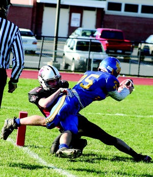 Justin Hovey battles for the tackle near the end zone for the Greencastle Falcons in the Keystone Youth Football League playoff contest against the Waynesboro Stallions.