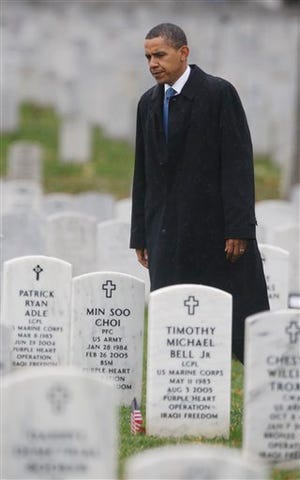 President Barack Obama walks among the grave markers during a unannounced visit Wednesday to Section 60 at Arlington National Cemetery in Arlington, Va.