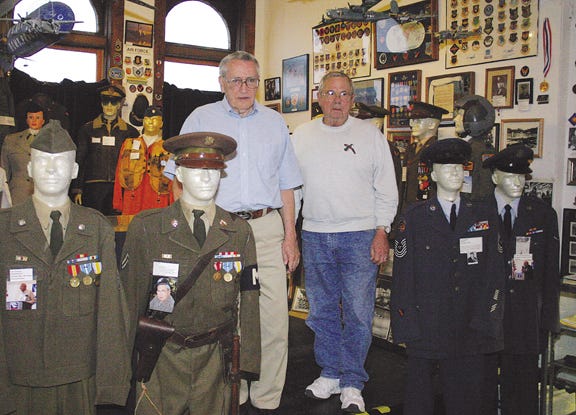 Jack Murphy and Bob Brackney of the Livingston County War Museum stand with manaquins donned in military uniforms Tuesday. Volunteers like Murphy and Brackney provide the museum their experience as veterans of the Armed Forces.