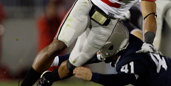 Ohio State's Ray Small (82) is tackled by Penn State punter Jeremy Boone (41) during the second half of an NCAA college football game in State College, Pa., Saturday, Nov. 7, 2009. Ohio State won 24-7.(AP Photo/Carolyn Kaster)