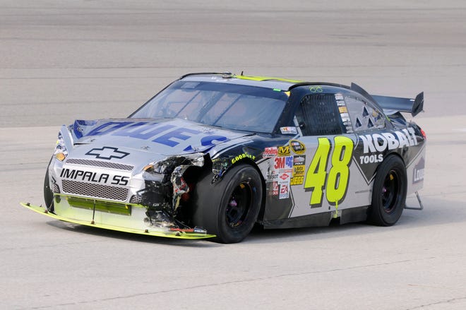 Jimmie Johnson drives his damaged car to the garage after wrecking the No. 48 Lowe’s Chevrolet on lap three of the Dickies 500 last Sunday at Texas Motor Speedway in Fort Worth.