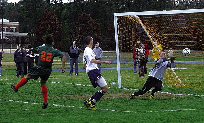 Apponequet goalkeeper Tyler Whalen makes a diving save on a shot from a Hopkinton player during Wednesday's quarterfinal playoff game.