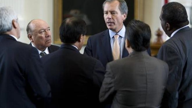 Lt. Gov. David Dewhurst speaks with senators Wednesday after the passage of Senate Bill 2. The bill, also approved by a House committee, would keep the Texas Department of Transportation and other agencies from ceasing to exist under the Texas sunset law.