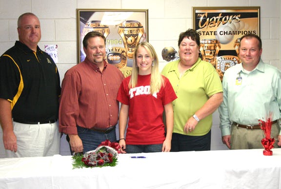 St. Amant’s Kelly Luquette signed a scholarship to Troy State University in Alabama Wednesday afternoon in the Gold Dome. Pictured are St. Amant head softball coach Scott Nielson, Ronnie Luquette, dad; Kelly Luquette, Ginger Luquette, mom; and St. Amant principal Steve Westbrook.
