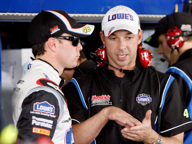 Driver Jimmie Johnson, left, talks with crew chief Chad Knaus during practice for Sunday's NASCAR Sprint Cup Checker O'Reilly Auto Parts 500 auto race on Friday in Avondale, Ariz.