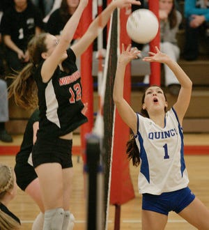 North Quincy's Rose Bennett, left, and Quincy's Julia Yee battle at the net.