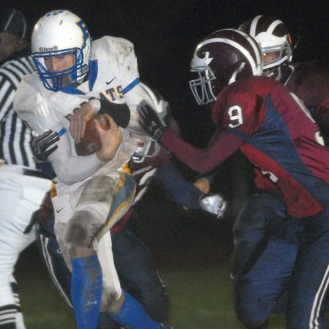 Bacon's Brennden Cullen, left, tries to avoid a tackle from Windham defenders including Alex Partosan, right, during a football game at Windham High School Friday, November 13, 2009.