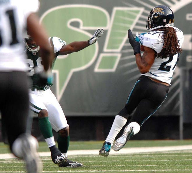 Jaguars cornerback Rashean Mathis (right) intercepts a pass intended for New York Jets receiver Jerricho Cotchery on the Jets' first offensive play of the game. The Jaguars went on to win 24-22 Sunday. (RICK WILSON/The Times-Union)