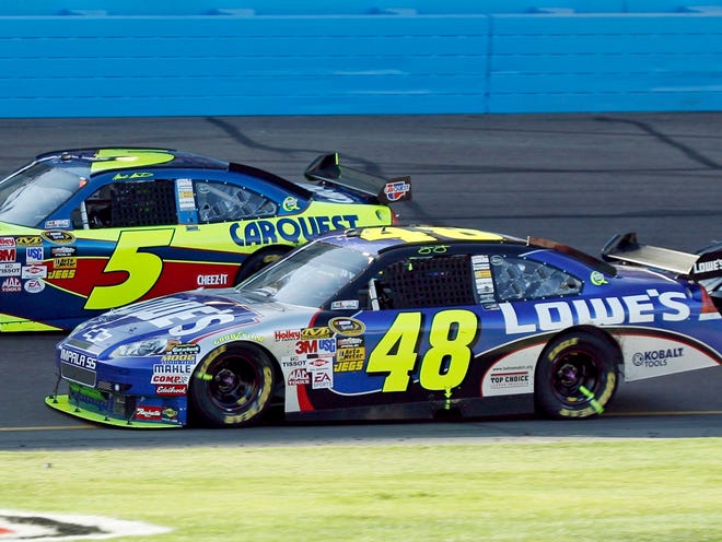 Mark Martin (5) and Jimmie Johnson (48) race side-by-side during the Checker O'Reilly Auto Parts 500 race on Sunday at Phoenix International Raceway in Avondale, Ariz., Sunday.