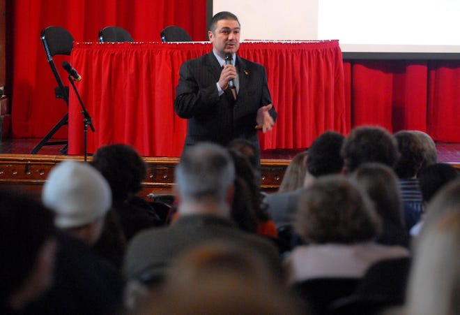 Nicholas Karacostas, the Supreme President of the Order of the American Hellenic Educational Progressive Association (AHEPA), addresses a crowd at Norwich Free Academy's Slater Auditorium Saturday, November 14, 2009, during the first ever Hellenic History Trophy tournament at NFA.