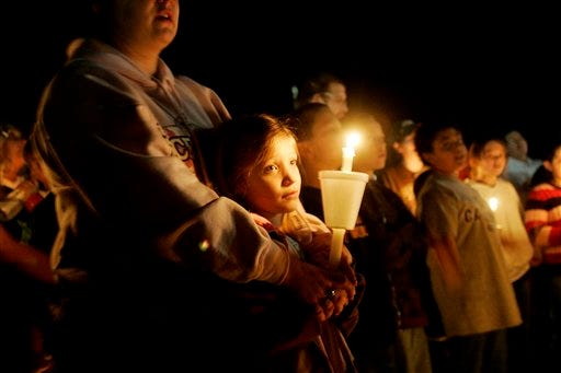 Crystal Weichett holds her daughter Callie during a candle light vigil for 5-year-old Shaniya Nicole Davis whose body was found Monday near Sanford, N.C. For a week, authorities feverishly searched for a 5-year-old girl across central North Carolina, only to find her body Monday off a rural road following accusations the girl's mother offered her for sex.