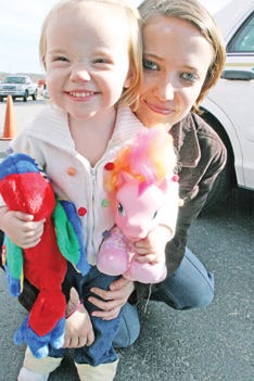 Morgan Hatmaker found some toys for Christmas at the Holiday Bureau on Friday with the help of her mother, Alicia Hatmaker, of Lake City.