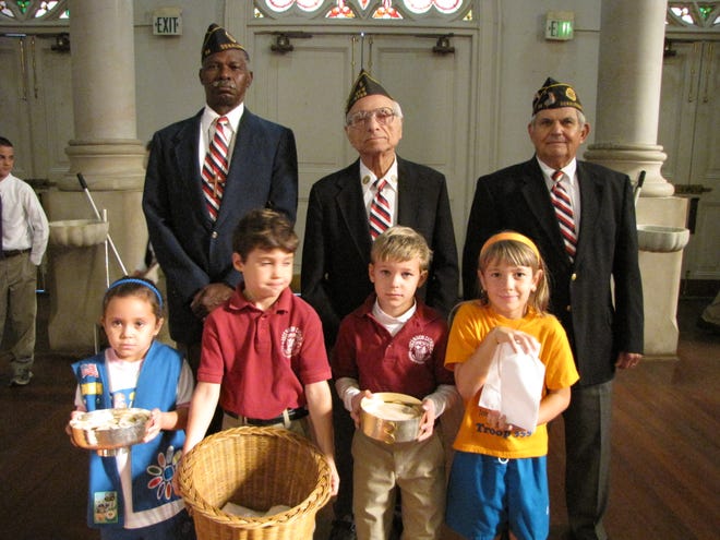 Ascension Catholic Elementary first graders are pictured with Veterans for the Offertory Procession at the Veterans' Day Mass on Nov. 11 at Ascension of Our Lord Catholic Church. Fr. Louis Oubre, co-chaplain of the school, presided at the mass. Pictured are front row,
l to r: Madison Tripode, Joel Landry, Jake Sagona, and Alexis Turner.
Back row, l to r: Clarence Brimmer, Joe Matassa, and Raymond Carbo.