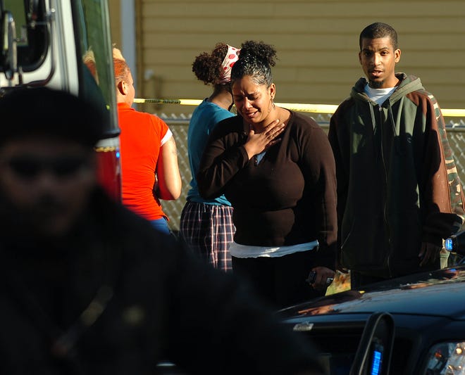 Onlookers get emotional as Brockton police investigate a fatal shooting Monday off North Main Street.
