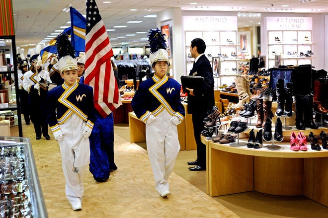 Ninth-graders Dima Rozenblat and Michele Sun lead the West Junior High School marching band past the women’s shoe department at the Columbia Mall Dillard’s, which Wednesday celebrated the completion of a multimillion-dollar renovation.